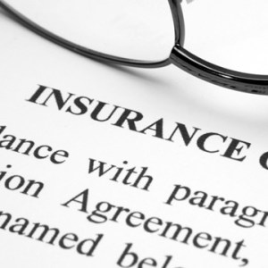 a close up of glasses on an insurance form
